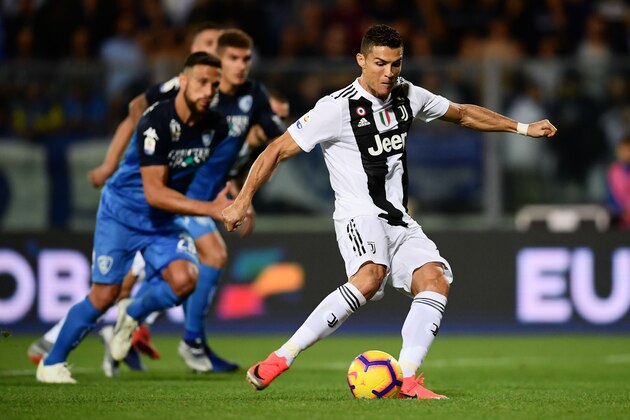 Juventus' Portuguese forward Cristiano Ronaldo shoots a penalty kick and scores a goal during the Italian Serie A football match between Empoli and Juventus on October 27, 2018 at the Carlo Castellani Stadium in Empoli. (Photo by MARCO BERTORELLO / AFP)        (Photo credit should read MARCO BERTORELLO/AFP/Getty Images)