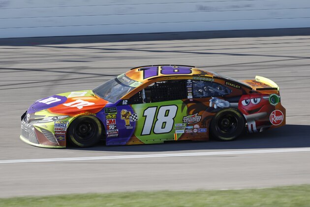 Kyle Busch (18) heads out of turn four during a NASCAR Cup Series auto race at Kansas Speedway in Kansas City, Kan., Sunday, Oct 21, 2018. (AP Photo/Colin E. Braley)