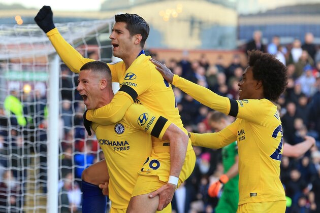 Chelsea's English midfielder Ross Barkley (L) celebrates with Chelsea's Spanish striker Alvaro Morata (C) and Chelsea's Brazilian midfielder Willian (R) after scoring their second goal during the English Premier League football match between Burnley and Chelsea at Turf Moor in Burnley, north west England on October 28, 2018. (Photo by Lindsey PARNABY / AFP) / RESTRICTED TO EDITORIAL USE. No use with unauthorized audio, video, data, fixture lists, club/league logos or 'live' services. Online in-match use limited to 120 images. An additional 40 images may be used in extra time. No video emulation. Social media in-match use limited to 120 images. An additional 40 images may be used in extra time. No use in betting publications, games or single club/league/player publications. /         (Photo credit should read LINDSEY PARNABY/AFP/Getty Images)