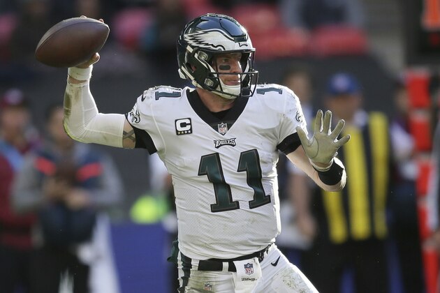 Philadelphia Eagles quarterback Carson Wentz (11) passes the ball during the first half of an NFL football game against Jacksonville Jaguars at Wembley stadium in London, Sunday, Oct. 28, 2018. (AP Photo/Tim Ireland)