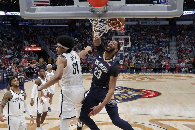 New Orleans Pelicans forward Anthony Davis (23) slam dunks over Brooklyn Nets center Jarrett Allen (31) in the second half of an NBA basketball game in New Orleans, Friday, Oct. 26, 2018. The Pelicans won 117-115. (AP Photo/Gerald Herbert)