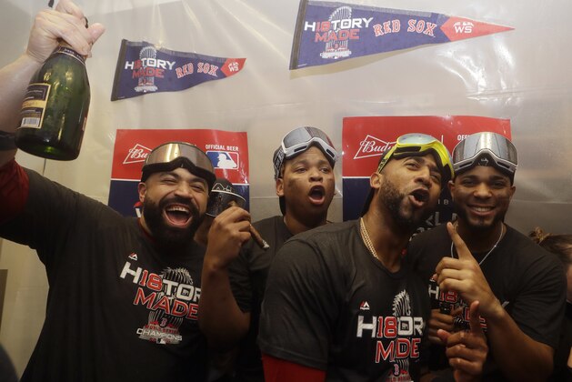 The Boston Red Sox, Sandy Leon, Rafael Devers, Eduardo Nunez, Xander Bogaerts celebrate in the clubhouse after Game 5 of baseball's World Series against the Los Angeles Dodgers on Sunday, Oct. 28, 2018, in Los Angeles. The Red Sox won 5-1 to win the series 4 games to 1. (AP Photo/Elise Amendola)