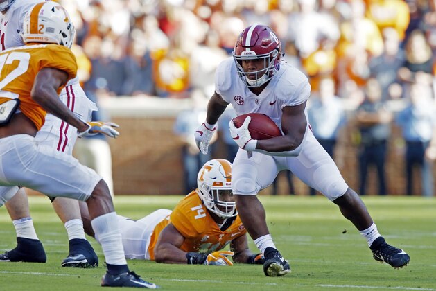 Alabama running back Josh Jacobs (8) runs for yardage as he is missed by Tennessee linebacker Quart'e Sapp (14) in the first half of an NCAA college football game Saturday, Oct. 20, 2018, in Knoxville, Tenn. (AP Photo/Wade Payne)