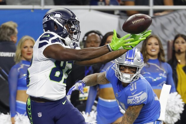 Seattle Seahawks wide receiver David Moore (83) catches a 15-yard pass for a touchdown as Detroit Lions cornerback Teez Tabor (31) defends during the first half of an NFL football game, Sunday, Oct. 28, 2018, in Detroit. (AP Photo/Paul Sancya)