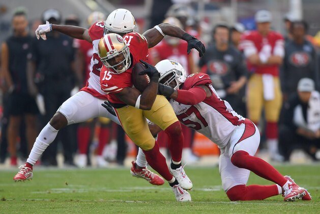 SANTA CLARA, CA - OCTOBER 07:  Pierre Garcon #15 of the San Francisco 49ers gets tackled by Josh Bynes #57 and Bene' Benwikere #23 of the Arizona Cardinals during the fourth quarter of an NFL football game at Levi's Stadium on October 7, 2018 in Santa Clara, California.  (Photo by Thearon W. Henderson/Getty Images)