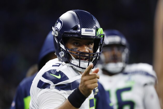 Seattle Seahawks quarterback Russell Wilson talks to a teammate during the first half of an NFL football game against the Detroit Lions, Sunday, Oct. 28, 2018, in Detroit. (AP Photo/Paul Sancya)