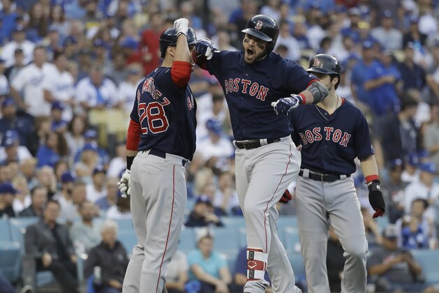 Boston Red Sox's Steve Pearce celebrates with J.D. Martinez (28) and Andrew Benintendi after hitting a two-run home run during the first inning in Game 5 of the World Series baseball game on Sunday, Oct. 28, 2018, in Los Angeles. (AP Photo/David J. Phillip)