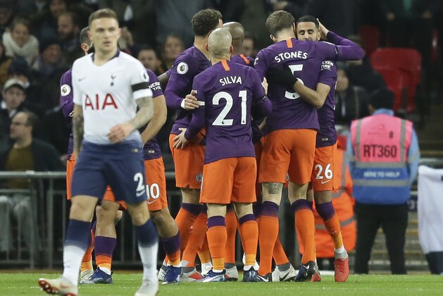 Manchester City's Riyad Mahrez, right, celebrates after scoring the opening goal during the English Premier League soccer match between Tottenham Hotspur and Manchester City at Wembley stadium in London, England, Monday, Oct. 29, 2018. (AP Photo/Tim Ireland)