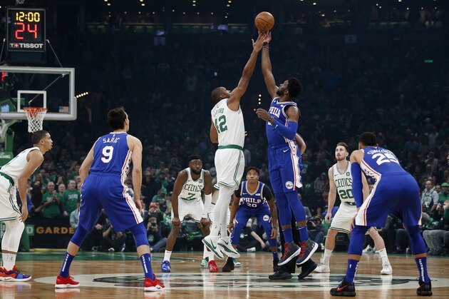 Boston Celtics' Al Horford (42) and Philadelphia 76ers' Joel Embiid (21) tip off during the first half of an NBA basketball game in Boston, Tuesday, Oct 16, 2018. (AP Photo/Michael Dwyer)