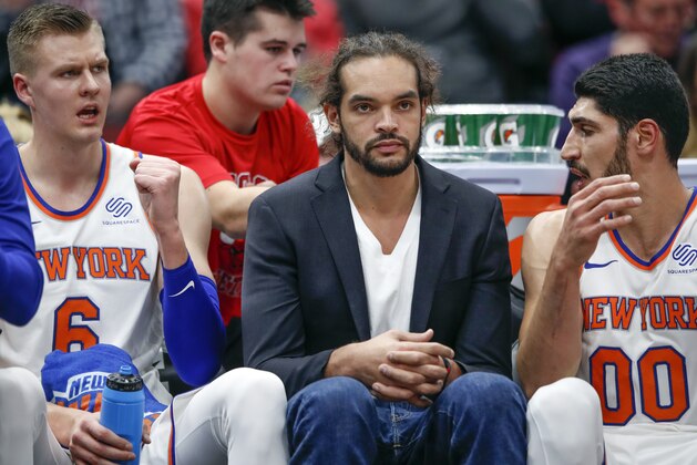 New York Knicks center Joakim Noah, center, sits on the bench between forward Kristaps Porzingis, left, and center Enes Kanter, right, during the first half of an NBA basketball game against the Chicago Bulls, Saturday, Dec. 9, 2017, in Chicago. (AP Photo/Kamil Krzaczynski)