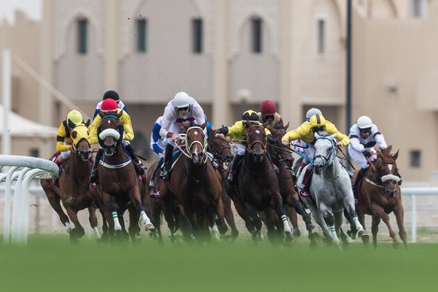 DOHA, QATAR - FEBRUARY 24:  Horses take the turn into the home straight in the 2000m Al Rayyan Breeders Cup race at Al Rayyan Racecourse on February 24, 2018 in Doha, Qatar.  (Photo by Neville Hopwood/Getty Images)