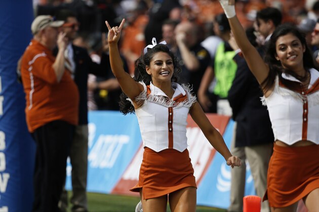 A member of the Texas Longhorns cheerleaders performs during the first half of an NCAA college football game against the Oklahoma Sooners, Saturday, Oct. 6, 2018, in Dallas, Texas. (AP Photo/Roger Steinman)