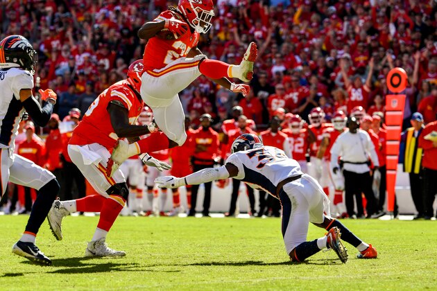KANSAS CITY, MO - OCTOBER 28: Kareem Hunt #27 of the Kansas City Chiefs hurdles over Will Parks #34 of the Denver Broncos on his way to an impressive touchdown run during the third quarter of the game at Arrowhead Stadium on October 28, 2018 in Kansas City, Missouri. (Photo by Peter Aiken/Getty Images)