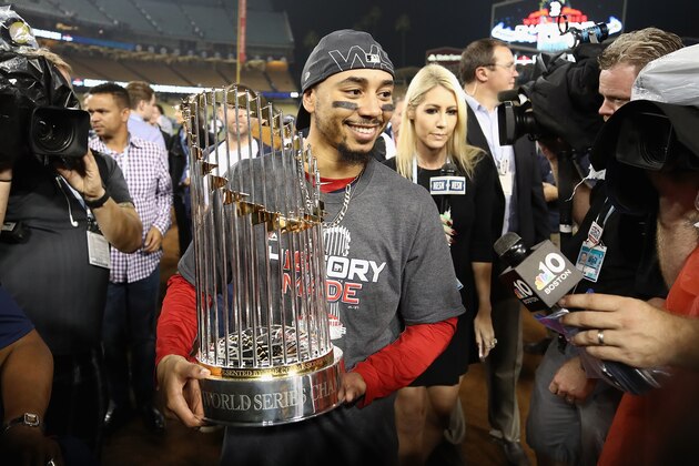 LOS ANGELES, CA - OCTOBER 28:  Mookie Betts #50 of the Boston Red Sox celebrates with the World Series trophy after his team's 5-1 win over the Los Angeles Dodgers in Game Five of the 2018 World Series at Dodger Stadium on October 28, 2018 in Los Angeles, California.  (Photo by Ezra Shaw/Getty Images)