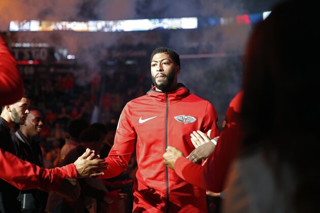 New Orleans Pelicans forward Anthony Davis walks onto the court ruling player introductions as part of pre-game festivities in before an NBA basketball game against the LA Clippers in New Orleans, Tuesday, Oct. 23, 2018. (AP Photo/Gerald Herbert)