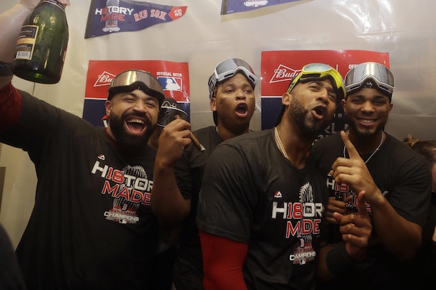 The Boston Red Sox, Sandy Leon, Rafael Devers, Eduardo Nunez, Xander Bogaerts celebrate in the clubhouse after Game 5 of baseball's World Series against the Los Angeles Dodgers on Sunday, Oct. 28, 2018, in Los Angeles. The Red Sox won 5-1 to win the series 4 games to 1. (AP Photo/Elise Amendola)