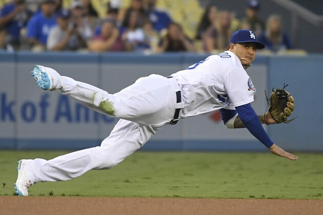 LOS ANGELES, CA - AUGUST 31: Manny Machado #8 of the Los Angeles Dodgers makes a throw to first base to put out Eduardo Escobar #14 of the Arizona Diamondbacks in the first inning at Dodger Stadium on August 31, 2018 in Los Angeles, California. (Photo by John McCoy/Getty Images)