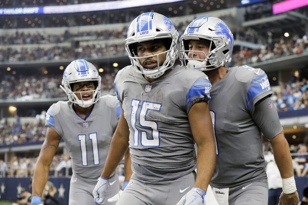 FILE - In this Sunday, Sept. 30, 2018 file photo, Detroit Lions wide receiver Golden Tate (15) is congratulated by quarterback Matthew Stafford (9) and wide receiver Marvin Jones (11) after scoring a touchdown in the second half of an NFL football game against the Dallas Cowboys in Arlington, Texas. Detroit Lions wide receiver Golden Tate was driving to work Tuesday, Oct. 2, 2018 when he was behind a two-car accident on a freeway. He ended up spending about 45 minutes to help a woman and her young daughter. (AP Photo/Eric Gay, File) FILE - In this Sunday, Sept. 30, 2018 file photo, Detroit Lions wide receiver Golden Tate (15) is congratulated by quarterback Matthew Stafford (9) and wide receiver Marvin Jones (11) after scoring a touchdown in the second half of an NFL football game against the Dallas Cowboys in Arlington, Texas. Detroit Lions wide receiver Golden Tate was driving to work Tuesday, Oct. 2, 2018 when he was behind a two-car accident on a freeway. He ended up spending about 45 minutes to help a woman and her young daughter. (AP Photo/Eric Gay, File)