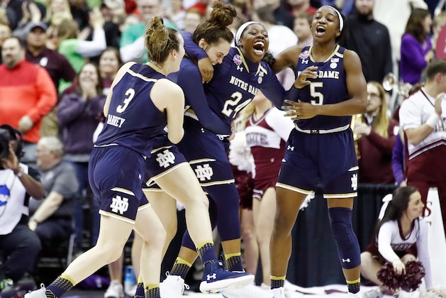 COLUMBUS, OH - APRIL 01:  Arike Ogunbowale #24 of the Notre Dame Fighting Irish is congratulated by her teammates Marina Mabrey #3, Kathryn Westbeld #33 and Jackie Young #5 after scoring the game winning basket with 0.1 seconds remaining in the fourth quarter to defeat the Mississippi State Lady Bulldogs in the championship game of the 2018 NCAA Women's Final Four at Nationwide Arena on April 1, 2018 in Columbus, Ohio. The Notre Dame Fighting Irish defeated the Mississippi State Lady Bulldogs 61-58.  (Photo by Andy Lyons/Getty Images)