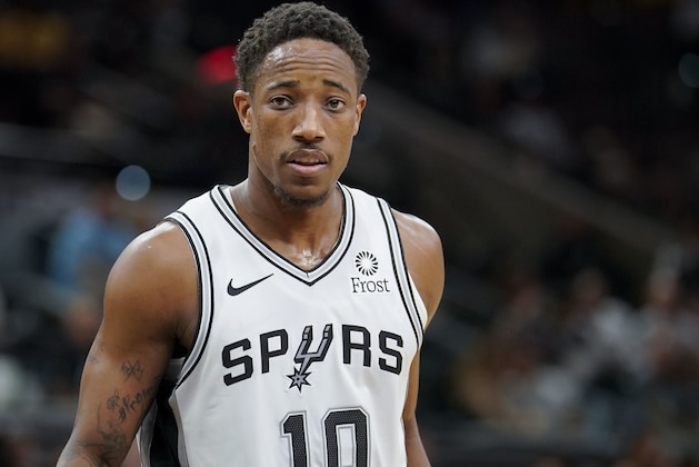 San Antonio Spurs' DeMar DeRozan walks up court during the first half of an NBA preseason basketball game against the Miami Heat, Sunday, Sept. 30, 2018, in San Antonio. (AP Photo/Darren Abate)
