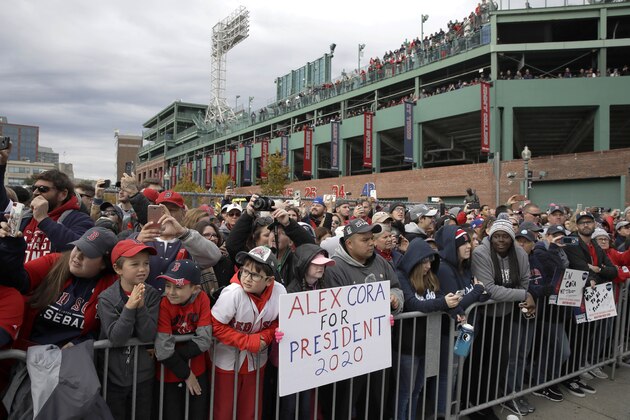 Boston Red Sox fans stand outside Fenway Park, waiting to watch the team's parade celebrating the World Series championship over the Los Angeles Dodgers, Wednesday, Oct. 31, 2018, in Boston. (AP Photo/Charles Krupa)