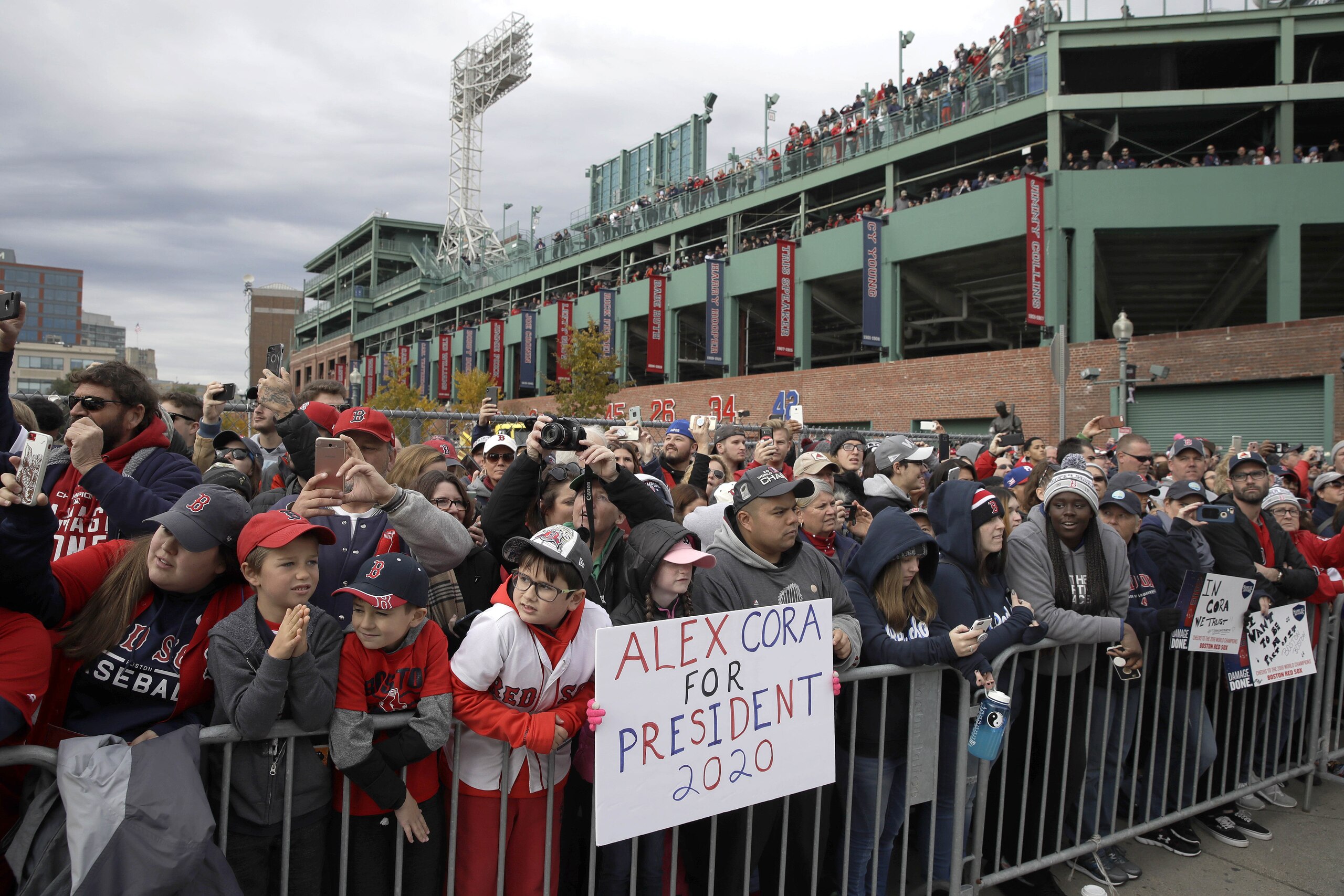 Boston Red Sox fans stand outside Fenway Park, waiting to watch the team's parade celebrating the World Series championship over the Los Angeles Dodgers, Wednesday, Oct. 31, 2018, in Boston. (AP Photo/Charles Krupa)
