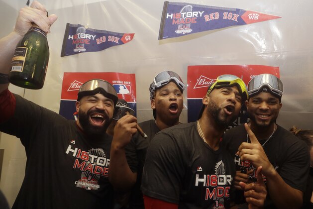 The Boston Red Sox, Sandy Leon, Rafael Devers, Eduardo Nunez, Xander Bogaerts celebrate in the clubhouse after Game 5 of baseball's World Series against the Los Angeles Dodgers on Sunday, Oct. 28, 2018, in Los Angeles. The Red Sox won 5-1 to win the series 4 games to 1. (AP Photo/Elise Amendola)