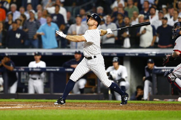 NEW YORK, NEW YORK - OCTOBER 09:  Brett Gardner #11 of the New York Yankees hits a sac fly to score Gary Sanchez #24 against Rick Porcello #22 of the Boston Red Sox during the fifth inning in Game Four of the American League Division Series at Yankee Stadium on October 09, 2018 in the Bronx borough of New York City. (Photo by Mike Stobe/Getty Images)