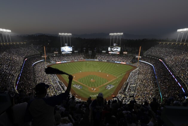 Fans cheer from the top of Dodger Stadium during Game 4 of the World Series baseball game between the Boston Red Sox and Los Angeles Dodgers on Saturday, Oct. 27, 2018, in Los Angeles. (AP Photo/Elise Amendola)