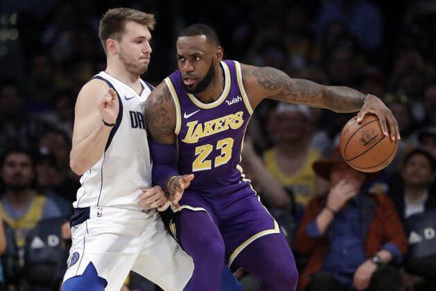 Los Angeles Lakers' LeBron James (23) is defended by Dallas Mavericks' Luka Doncic during the first half of an NBA basketball game Wednesday, Oct. 31, 2018, in Los Angeles. (AP Photo/Marcio Jose Sanchez)