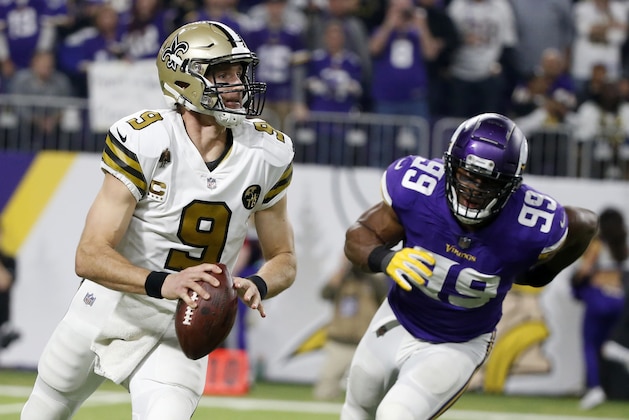 New Orleans Saints quarterback Drew Brees runs from Minnesota Vikings defensive end Danielle Hunter, right, during the second half of an NFL football game, Sunday, Oct. 28, 2018, in Minneapolis. (AP Photo/Bruce Kluckhohn)