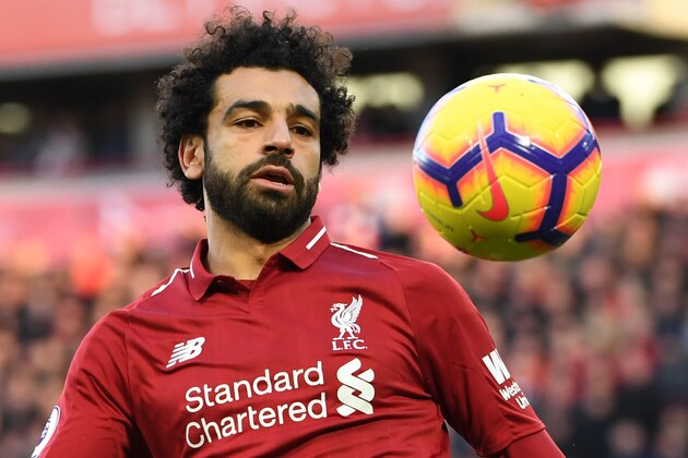Liverpool's Egyptian midfielder Mohamed Salah eyes the ball during the English Premier League football match between Liverpool and Cardiff City at Anfield in Liverpool, north west England on October 27, 2018. (Photo by Paul ELLIS / AFP) / RESTRICTED TO EDITORIAL USE. No use with unauthorized audio, video, data, fixture lists, club/league logos or 'live' services. Online in-match use limited to 120 images. An additional 40 images may be used in extra time. No video emulation. Social media in-match use limited to 120 images. An additional 40 images may be used in extra time. No use in betting publications, games or single club/league/player publications. /         (Photo credit should read PAUL ELLIS/AFP/Getty Images)