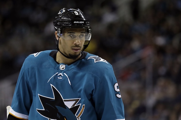 FILE - In this March 20, 2018, file photo, San Jose Sharks' Evander Kane waits for play to resume during the second period of the team's NHL hockey game against the New Jersey Devils in San Jose, Calif. The Sharks are closing in on a seven-year contract with Kane that will keep the high-scoring forward off the free-agent market. A person familiar with the negotiations says the contract is expected to be finalized on Wednesday. The person spoke to The Associated Press on Tuesday night, May 22, on condition of anonymity because the deal hasn’t been completed. (AP Photo/Marcio Jose Sanchez, File)