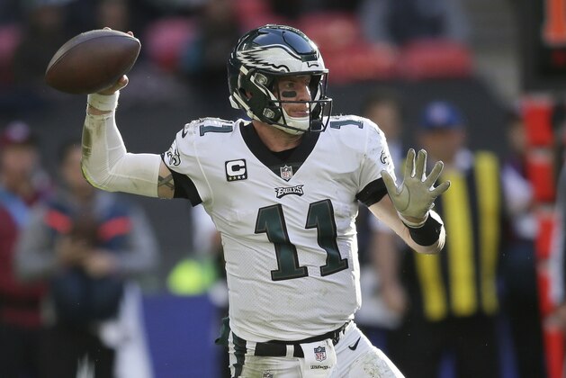 Philadelphia Eagles quarterback Carson Wentz (11) passes the ball during the first half of an NFL football game against Jacksonville Jaguars at Wembley stadium in London, Sunday, Oct. 28, 2018. (AP Photo/Tim Ireland)