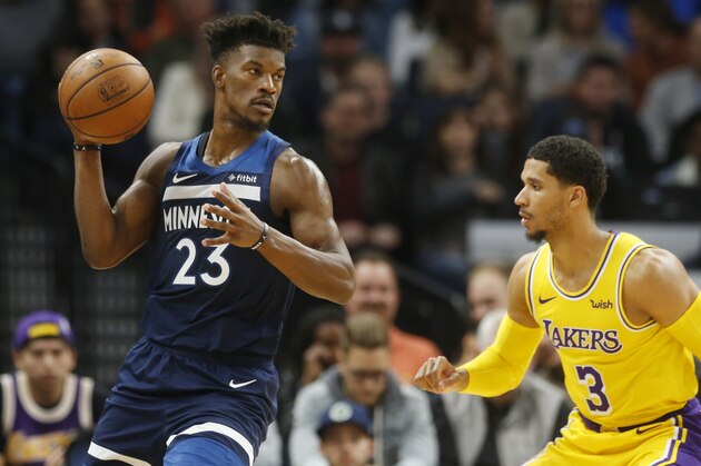 Minnesota Timberwolves' Jimmy Butler, left, looks to pass as Los Angeles Lakers' Josh Hart defends in the second half of an NBA basketball game Monday, Oct. 29, 2018, in Minneapolis.The Timberwolves won 124-120. (AP Photo/Jim Mone)