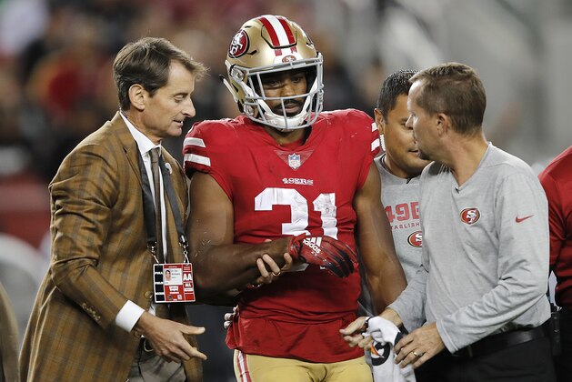 San Francisco 49ers running back Raheem Mostert (31) walks off the field with trainers during the second half of the team's NFL football game against the Oakland Raiders in Santa Clara, Calif., Thursday, Nov. 1, 2018. (AP Photo/John Hefti)
