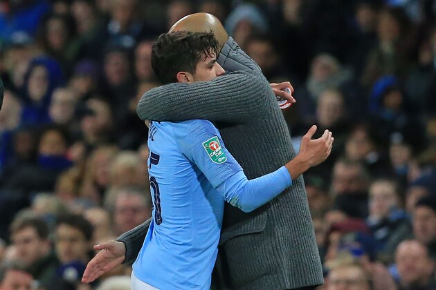 Manchester City's Spanish-born midfielder Brahim Diaz (L) is embraced by Manchester City's Spanish manager Pep Guardiola as he is substituted during the English League Cup, 4th round football match between Manchester City and Fulham at the Etihad Stadium in Manchester, north west England, on November 1, 2018. (Photo by Lindsey PARNABY / AFP) / RESTRICTED TO EDITORIAL USE. No use with unauthorized audio, video, data, fixture lists, club/league logos or 'live' services. Online in-match use limited to 120 images. An additional 40 images may be used in extra time. No video emulation. Social media in-match use limited to 120 images. An additional 40 images may be used in extra time. No use in betting publications, games or single club/league/player publications. /         (Photo credit should read LINDSEY PARNABY/AFP/Getty Images)