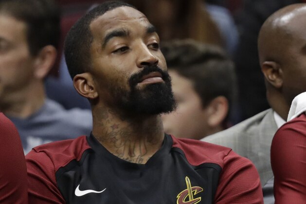 Cleveland Cavaliers' JR Smith watches from the bench during the first half of the team's NBA basketball game against the Denver Nuggets, Thursday, Nov. 1, 2018, in Cleveland. The Nuggets won 110-91. (AP Photo/Tony Dejak)
