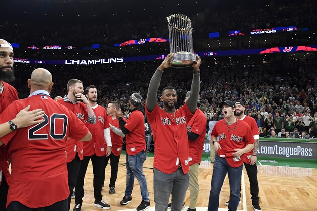 BOSTON, MA - NOVEMBER 1: Eduardo Nunez of the Boston Red Sox lifts the World Series Trophy during the game between the Milwaukee Bucks and the Boston Celtics on November 1, 2018 at the TD Garden in Boston, Massachusetts. NOTE TO USER: User expressly acknowledges and agrees that, by downloading and/or using this photograph, user is consenting to the terms and conditions of the Getty Images License Agreement. Mandatory Copyright Notice: Copyright 2018 NBAE (Photo by Brian Babineau/NBAE via Getty Images)