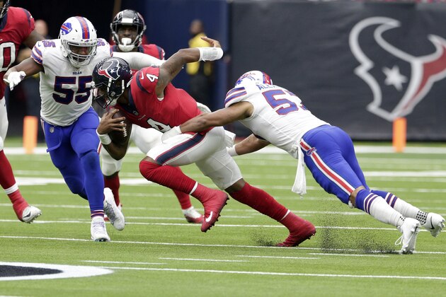 Houston Texans quarterback Deshaun Watson (4) tries to escape the grasp of Buffalo Bills linebacker Lorenzo Alexander (57) as Buffalo Bills defensive end Jerry Hughes (55) closes in during the second half of an NFL football game, Sunday, Oct. 14, 2018, in Houston. (AP Photo/Michael Wyke)