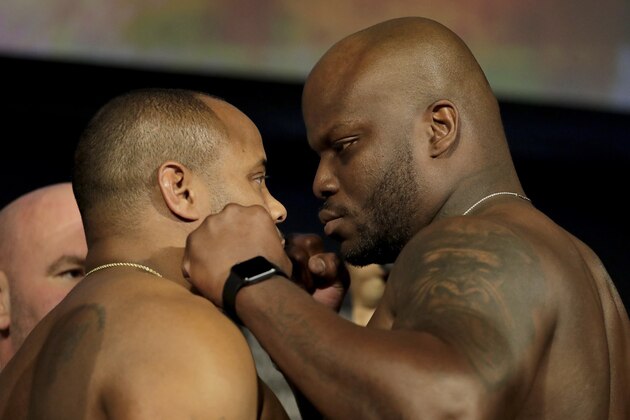 Daniel Cormier, left, and Derrick Lewis square off for photographers during the weigh-ins for their heavyweight mixed martial arts bout at UFC 230, Friday, Nov. 2, 2018, at Madison Square Garden in New York. (AP Photo/Julio Cortez)