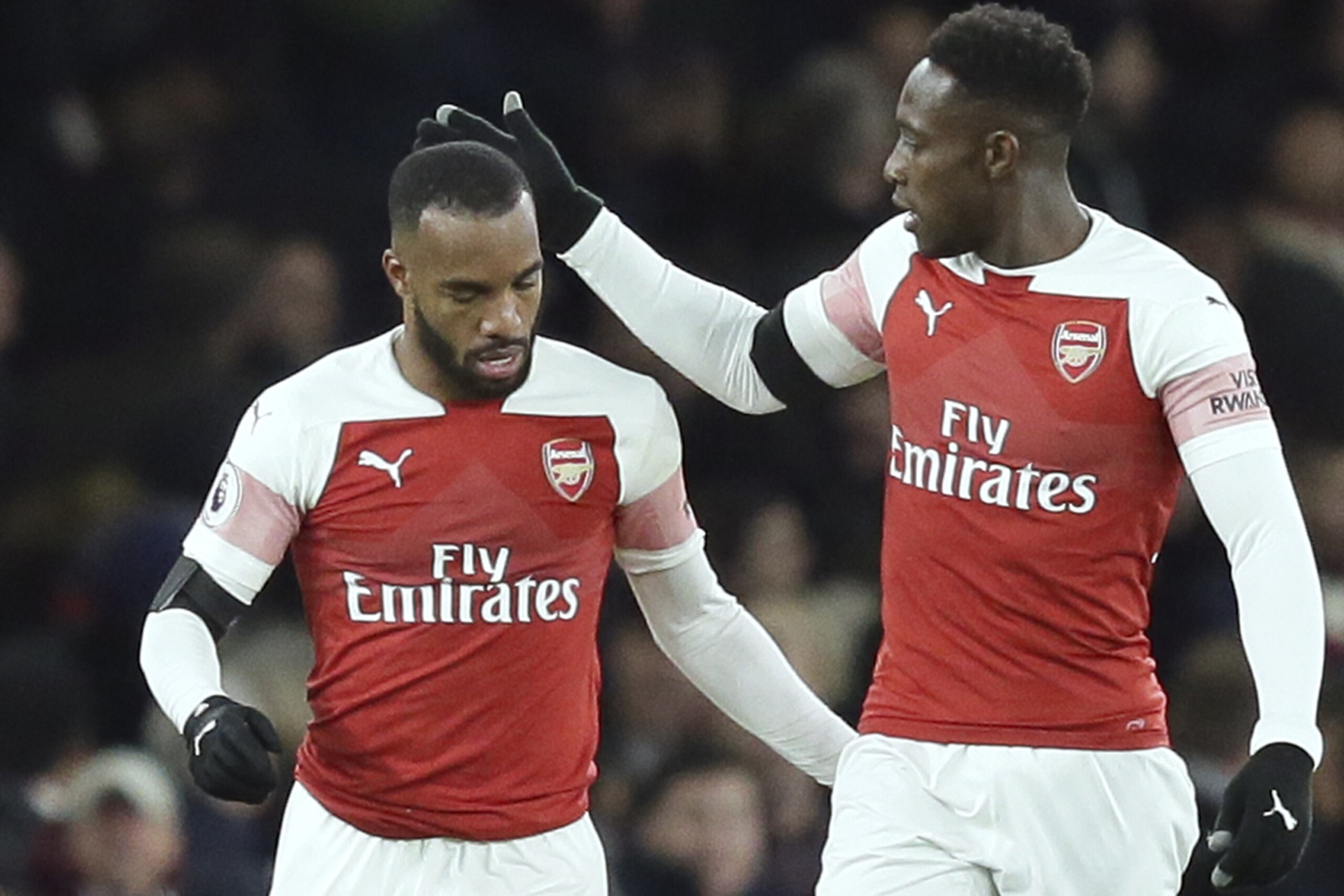 Arsenal's Alexandre Lacazette, left, celebrates with Danny Welbeck after scoring his side's first goal during the English Premier League soccer match between Arsenal and Liverpool at Emirates stadium in London, England, Saturday, Nov. 3, 2018. (AP Photo/Tim Ireland)