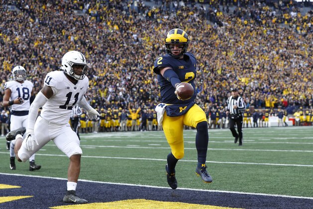 Michigan quarterback Shea Patterson (2) scores on a one-yard touchdown run as Penn State linebacker Micah Parsons (11) defends in the first half of an NCAA college football game in Ann Arbor, Mich., Saturday, Nov. 3, 2018. (AP Photo/Paul Sancya)