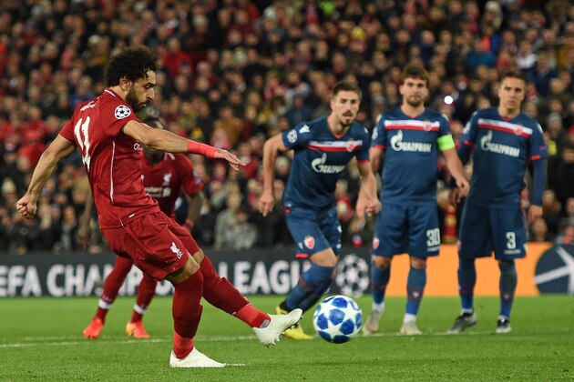 Liverpool's Egyptian midfielder Mohamed Salah (L) scores their third goal from the penalty spot during the UEFA Champions League group C football match between Liverpool and Red Star Belgrade at Anfield in Liverpool, north west England on October 24, 2018. (Photo by Oli SCARFF / AFP)        (Photo credit should read OLI SCARFF/AFP/Getty Images)
