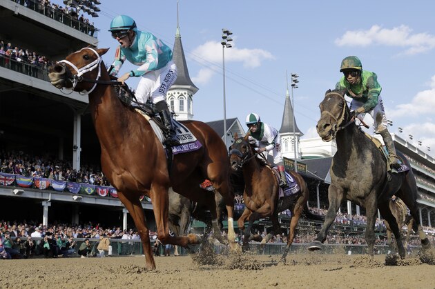 Florent Geroux, left, celebrates as he rides Monomoy Girl to victory as Joe Bravo, center, atop Blue Prize and Jose Ortiz, right, atop Wow Cat follow in the Breeders' Cup Distaff horse race at Churchill Downs, Saturday, Nov. 3, 2018, in Louisville, Ky. (AP Photo/Darron Cummings)