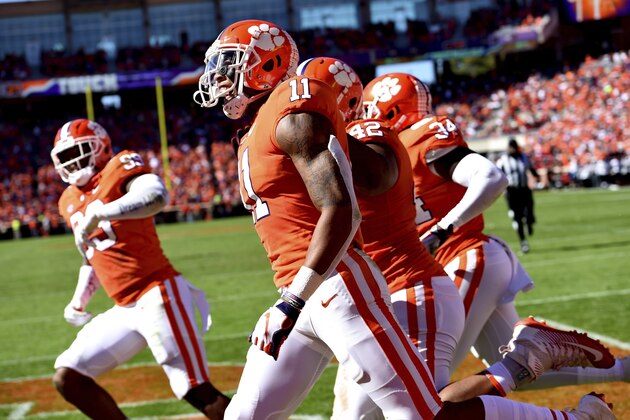 Clemson's Isaiah Simmons (11) celebrates after returning an interception for a touchdown during the first half of an NCAA college football game against Louisville, Saturday, Nov. 3, 2018, in Clemson, S.C. (AP Photo/Richard Shiro)