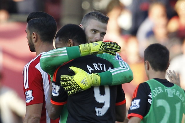 Manchester United's Spanish goalkeeper David de Gea embraces Manchester United's French striker Anthony Martial (2nd L) after the English Premier League football match between Southampton and Manchester United at St Mary's Stadium in Southampton, southern England on September 20, 2015. Manchester United won the game 3-2. AFP PHOTO / IAN KINGTON

RESTRICTED TO EDITORIAL USE. No use with unauthorized audio, video, data, fixture lists, club/league logos or 'live' services. Online in-match use limited to 75 images, no video emulation. No use in betting, games or single club/league/player publications.        (Photo credit should read IAN KINGTON/AFP/Getty Images)