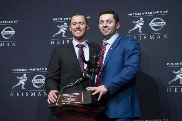 Oklahoma head football coach Lincoln Riley, left, stands with Oklahoma quarterback Baker Mayfield, winner of the Heisman Trophy, during a news conference Saturday, Dec. 9, 2017, in New York. (AP Photo/Craig Ruttle)