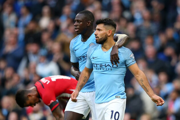 MANCHESTER, ENGLAND - NOVEMBER 04:  Sergio Aguero of Manchester City celebrates with teammate Benjamin Mendy of Manchester City after assisting Raheem Sterling of Manchester City who scored their team's fourth goal during the Premier League match between Manchester City and Southampton FC at Etihad Stadium on November 4, 2018 in Manchester, United Kingdom.  (Photo by Alex Livesey/Getty Images)