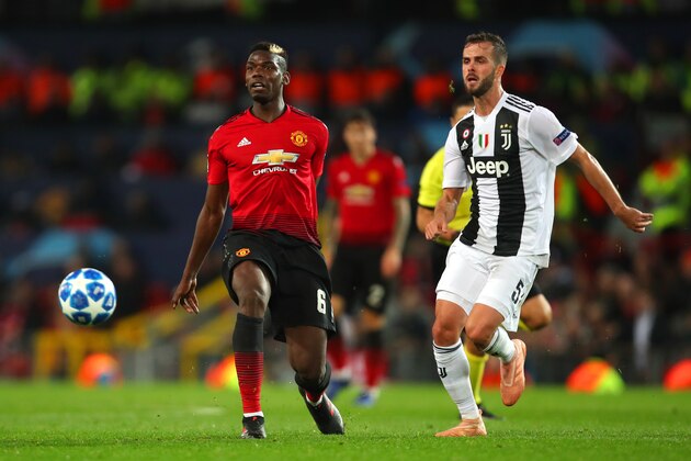 MANCHESTER, ENGLAND - OCTOBER 23:  Miralem Pjanic of Juventus competes with Paul Pogba of Manchester United during the Group H match of the UEFA Champions League between Manchester United and Juventus at Old Trafford on October 23, 2018 in Manchester, United Kingdom. (Photo by Robbie Jay Barratt - AMA/Getty Images)
